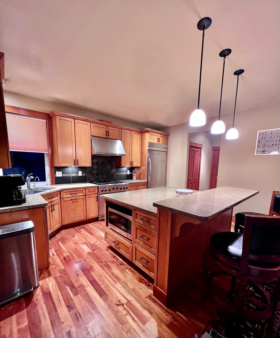 Kitchen area with large granite island, centered perfectly in the kitchen. 