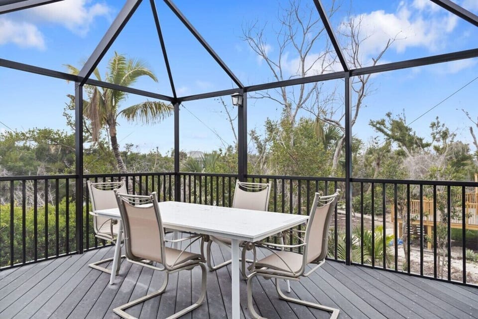 Patio with seating for four and screened lanai