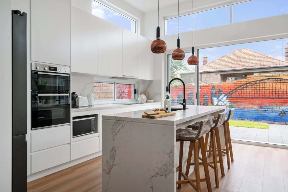 Sleek and contemporary kitchen with a stylish counter, perfect for casual dining or entertaining in effortless style.