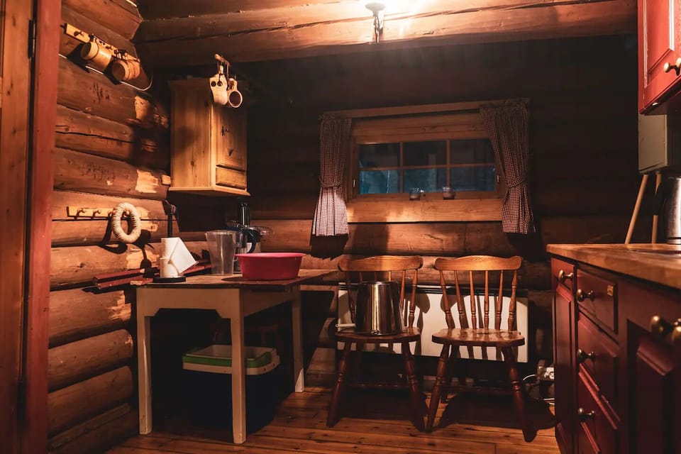 Kitchen has electric stove, fridge, and is fully stacked with cookware