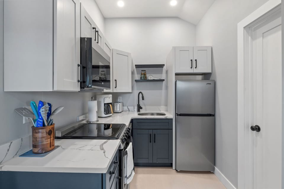 Kitchen with coffee maker, toaster, and all standard appliances, including dishwasher.