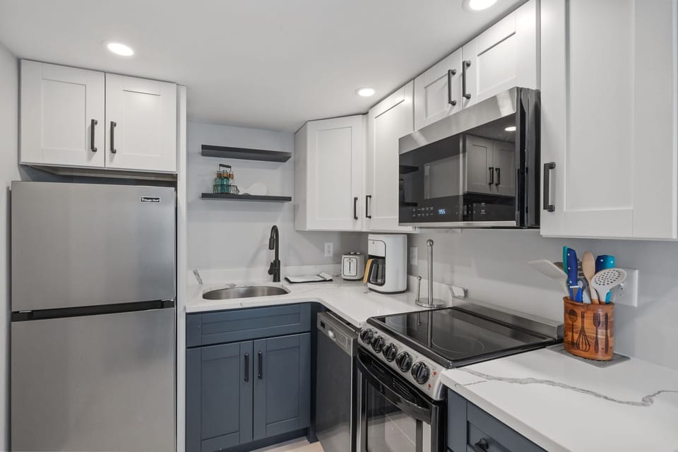 Kitchen with coffee maker, toaster, and all standard appliances, including dishwasher.