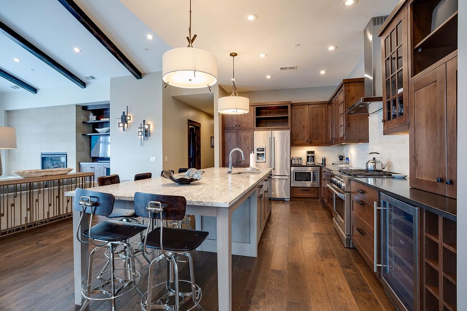 You'll love cooking in this spacious kitchen with granite countertops, stainless appliances, and a breakfast bar perfect for morning coffee.