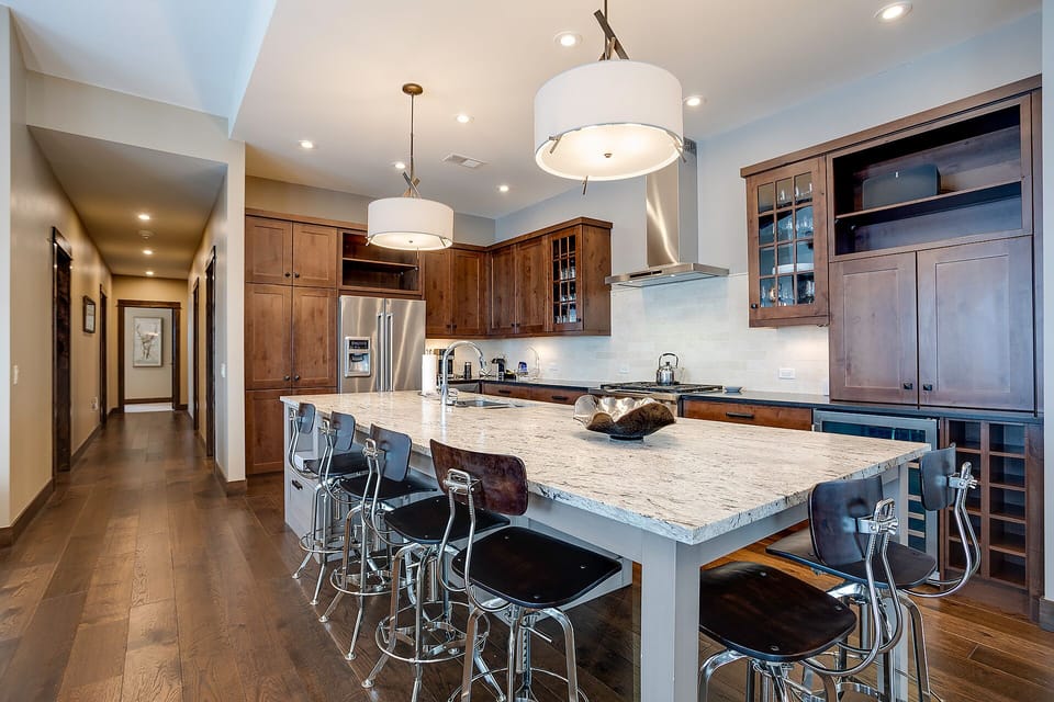 Your gourmet kitchen features granite counters, stainless steel appliances, and a spacious island perfect for gathering with loved ones.
