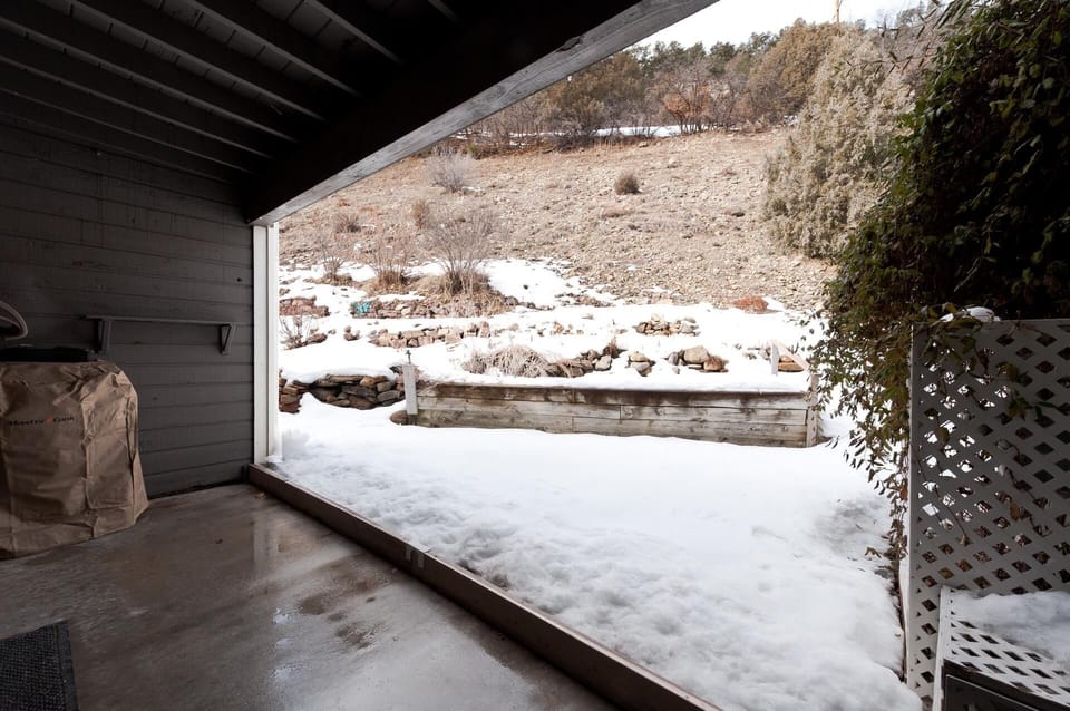 Main Floor Covered Patio - Access is thru the downstairs bedrooms (Outdoor furniture will be added April 2024).