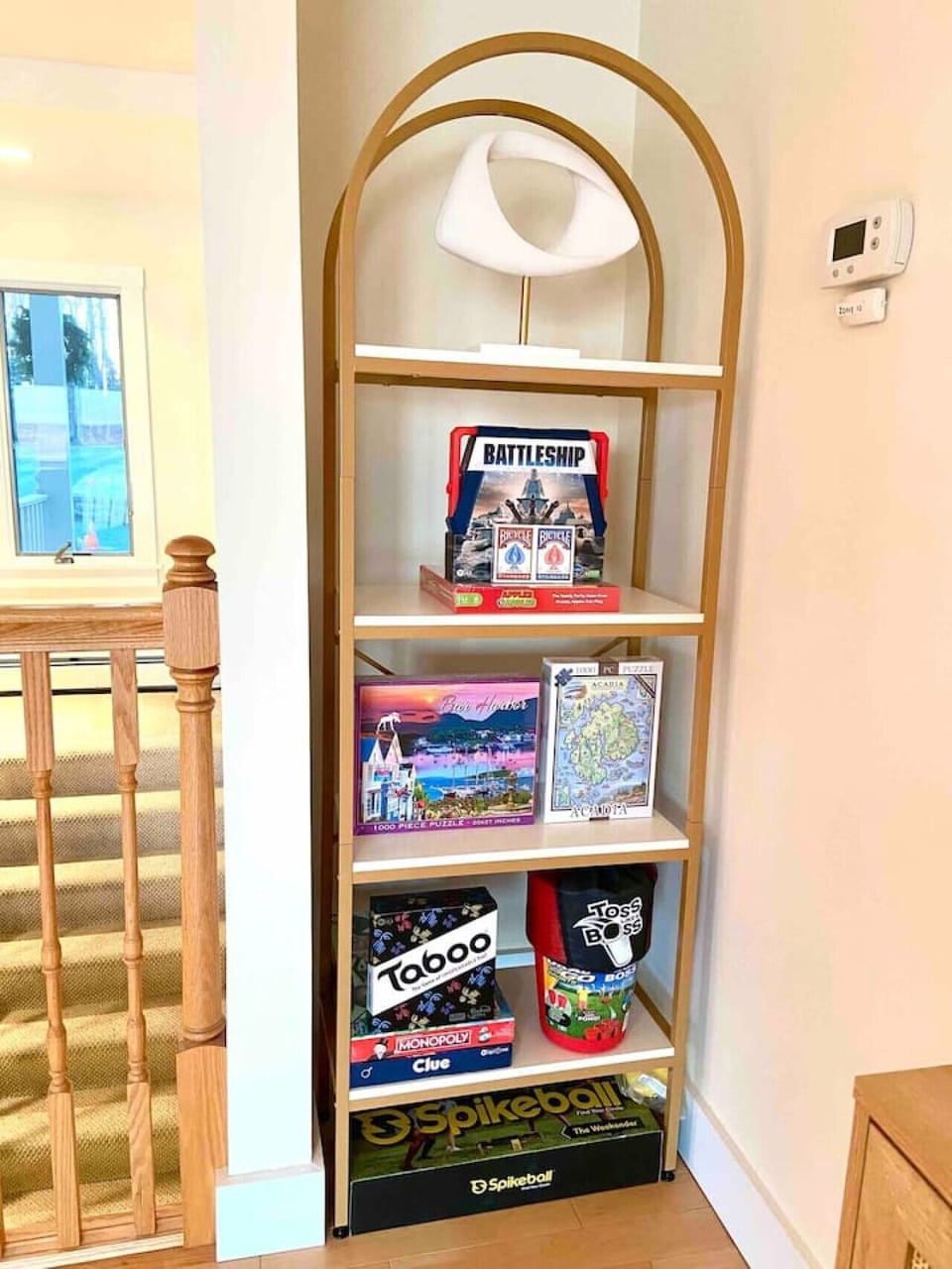 Game nook - including Spikeball, Monopoly, Apples to Apples, Clue, Battleship, Bar Harbor Puzzle, Mount Desert Island Puzzle, playing cards and more.