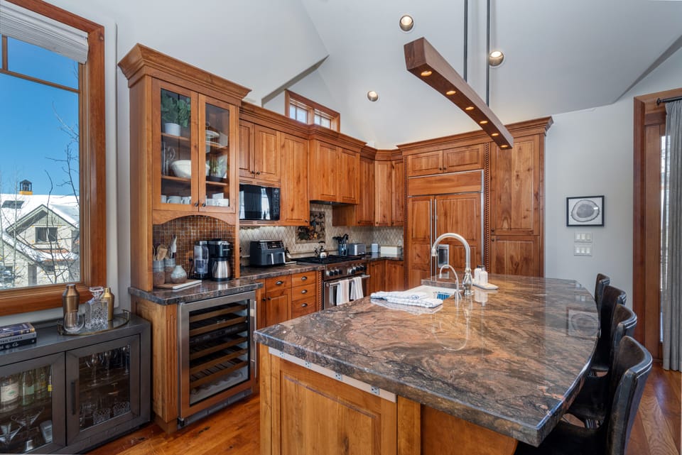 Kitchen - Fully stocked with serving items and extra appliances with bar stool seating at island for 4