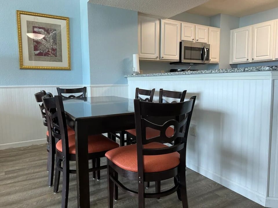 Simple dining table with modern chairs, perfect for casual meals or gatherings.