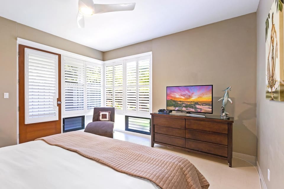 Experience comfort and tranquility in this island-inspired room with balcony garden views    