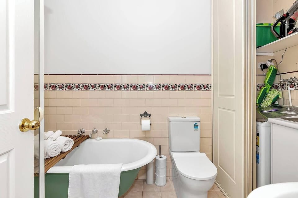 The classic bathroom comes with both a bathtub and shower and includes a laundry space for your everyday convenience.
