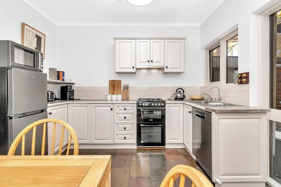 The kitchen comes well equipped to prepare meals at home, with stainless steel appliances and a coffee pod machine.
