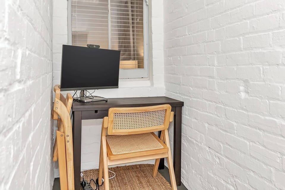 A dedicated workspace caters to those on a business trip with a desk and monitor.
