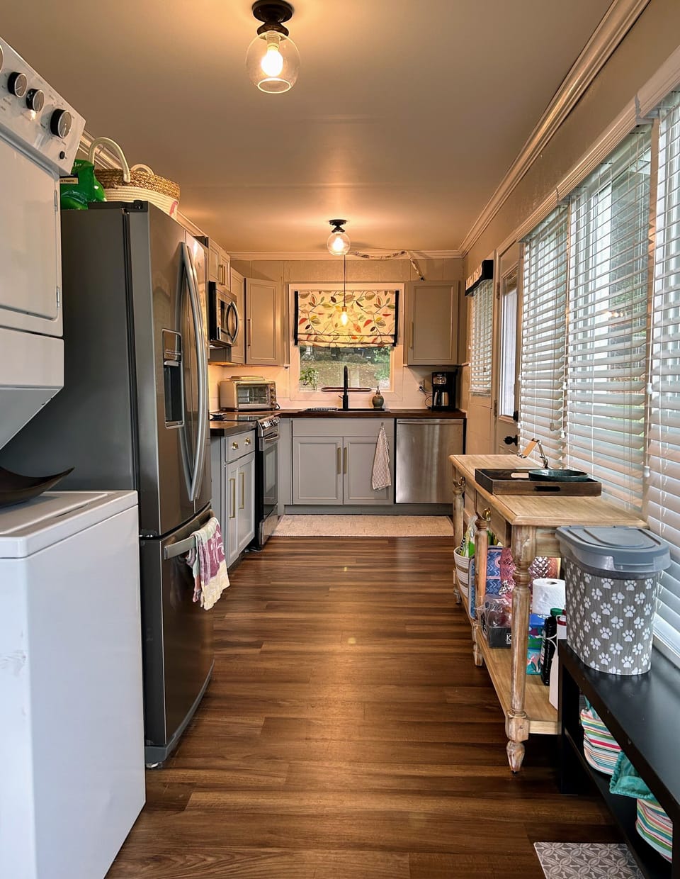 View of kitchen and stackable washer/dryer