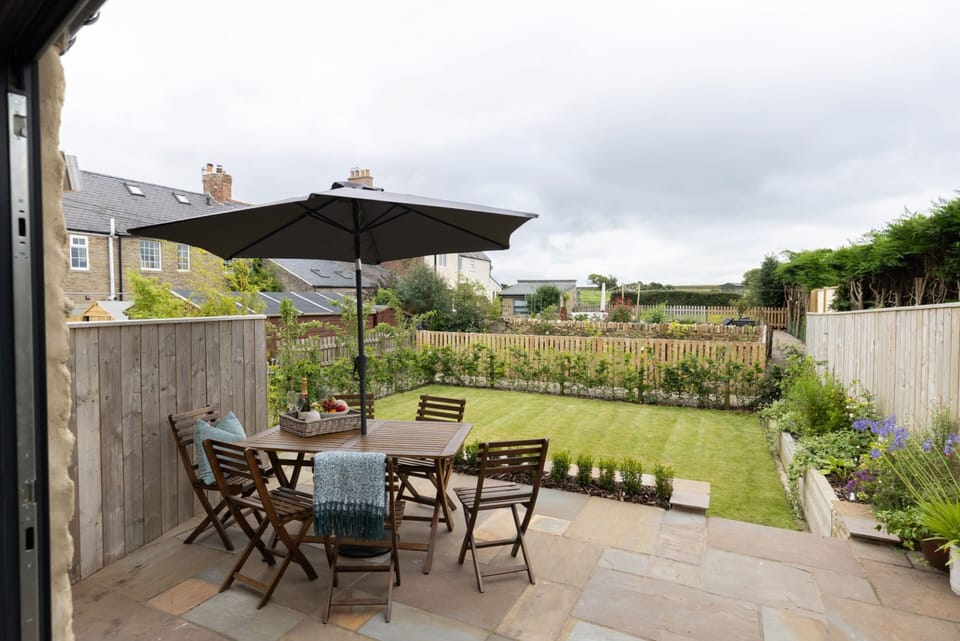 Breakfasting patio in south-facing rear garden