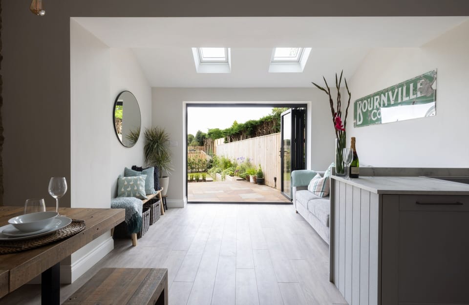 View from the lounge/kitchen door through bifold doors into the garden / patio area 