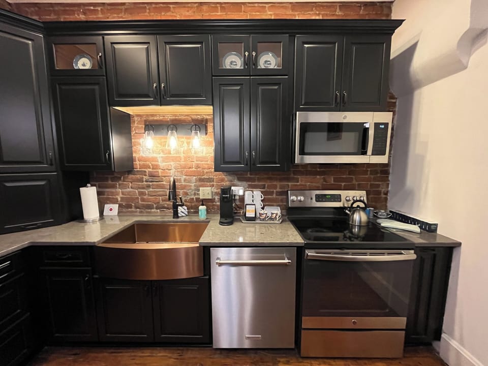 Gorgeous copper sink and exposed brick