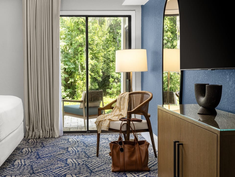 Retreat to restful nights in a serene bedroom with lush views just beyond the window.