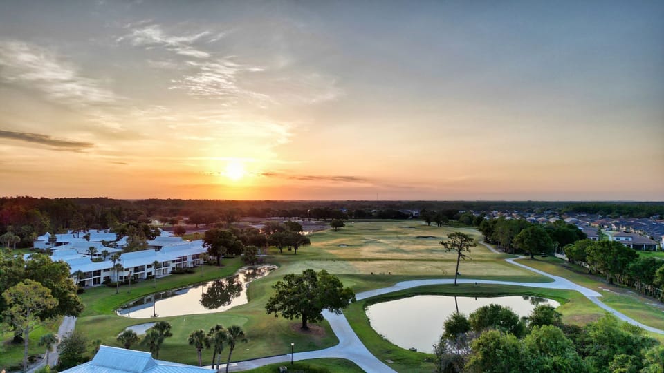 Golden hour paints the fairways — every swing framed by a perfect sunset.