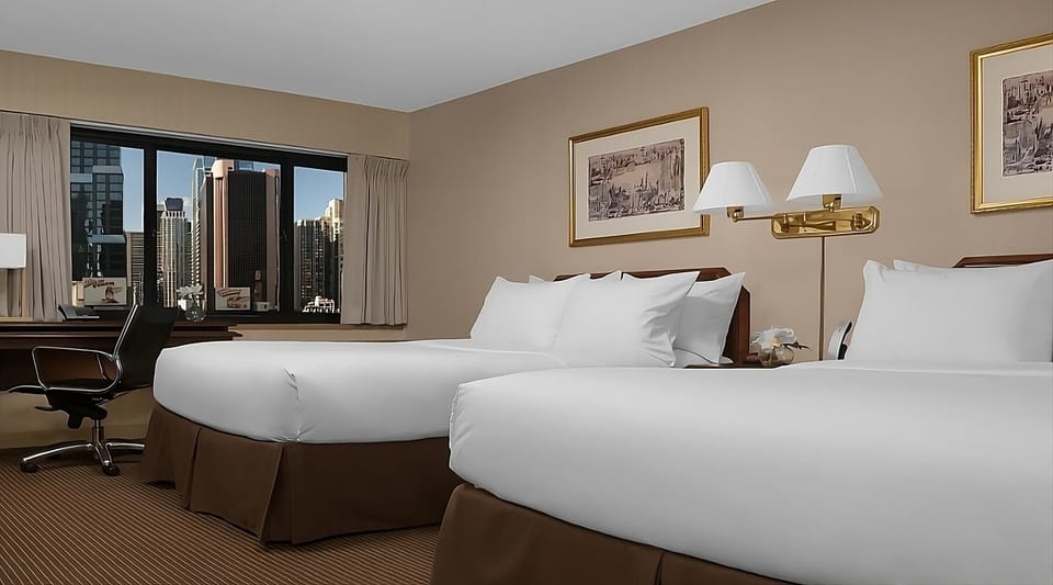 Settle in together with two plush beds and city views.