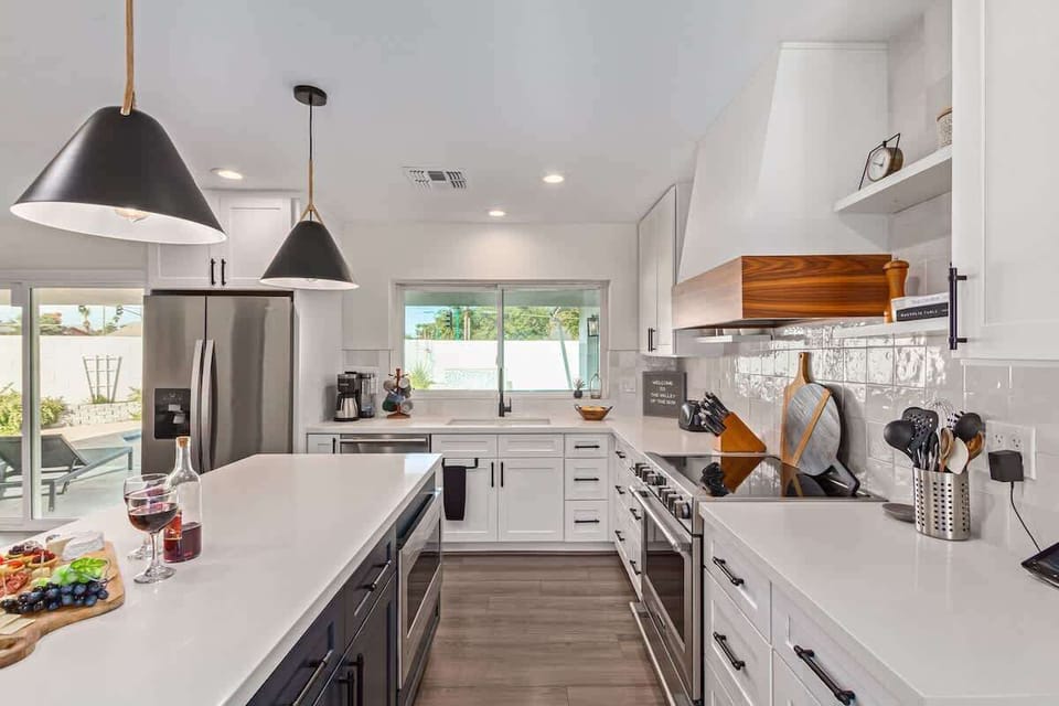 Fully equipped kitchen stocked with your basic cooking essentials, stainless steel appliances, and bar seating.