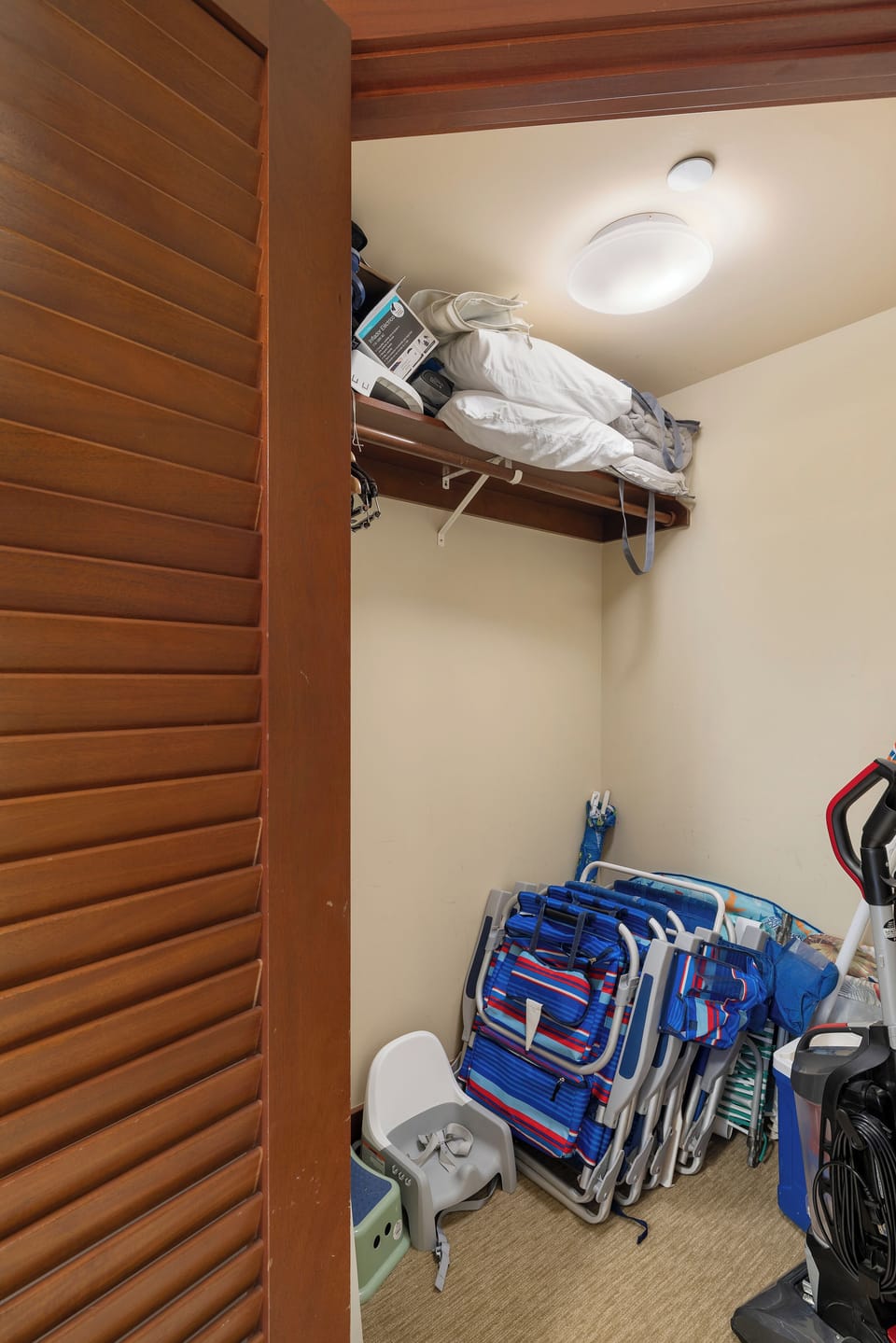 Clever storage maximizes your space with shelving above and folded chairs below.