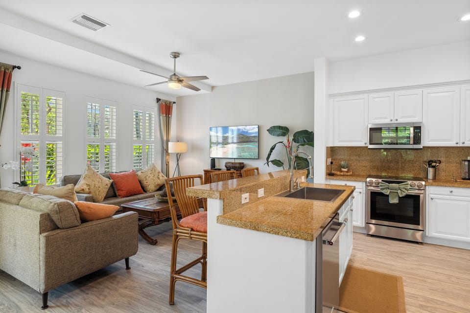 Plenty of seating and natural lighting in this seamless living and kitchen area.