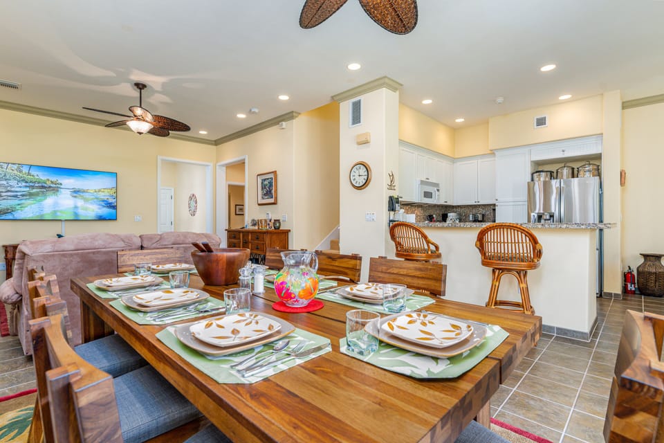 Dine in comfort with a view of the kitchen and open layout—perfect for leisurely island breakfasts or sunset dinners.