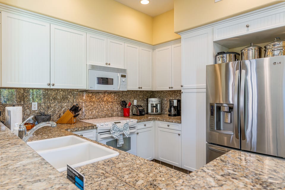 The chef-ready kitchen features granite countertops, full-size stainless appliances, and all you need for home-style meals.