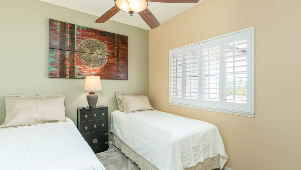 The third guest bedroom with twin beds and scenic views.