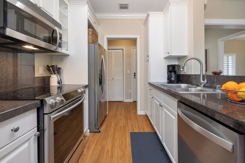 This hallway kitchen view showcases high-end finishes and functional design for easy entertaining.