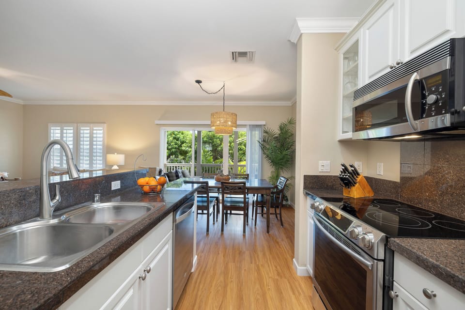 Cook like a pro in the gourmet kitchen with granite countertops, stainless steel appliances, and bar seating.