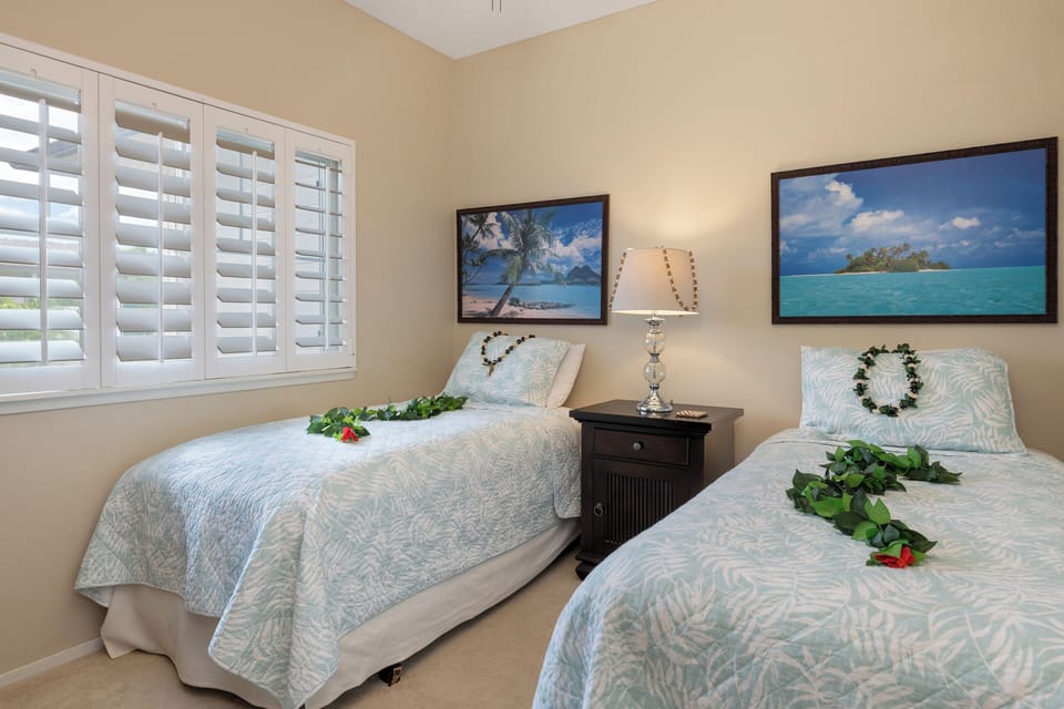 Perfect for families—this third bedroom/den features twin beds and charming coastal decor.