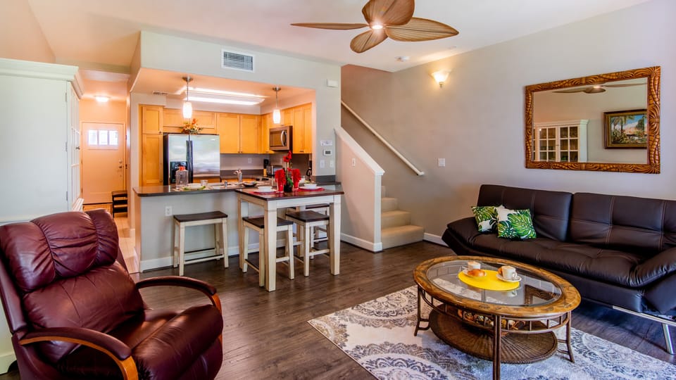 An open floor plan with kitchen, dining and living areas.