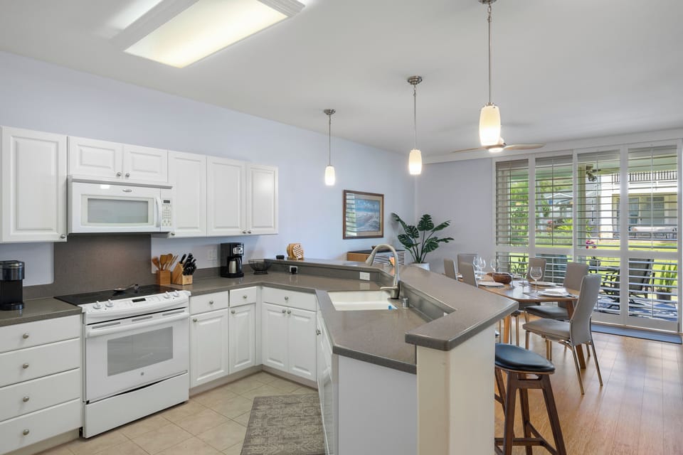 Your bright, open kitchen awaits with modern appliances and a breakfast bar perfect for morning coffee or casual meals together.