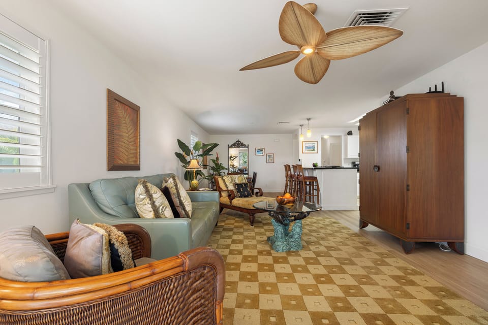 Relax in your tropical-inspired living area, where coastal charm meets comfort. Ceiling fans, plush seating, and island-style décor create the perfect retreat after a day of adventure.