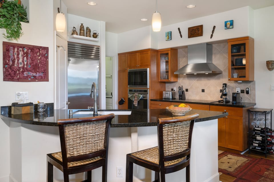 Create memorable meals in a chef-ready kitchen featuring stainless appliances, granite counters, and bar seating for casual dining.