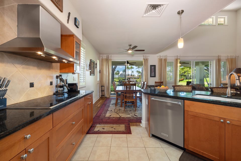 Enjoy effortless entertaining in the open-concept kitchen and dining space that flows into the lanai and lush backyard.