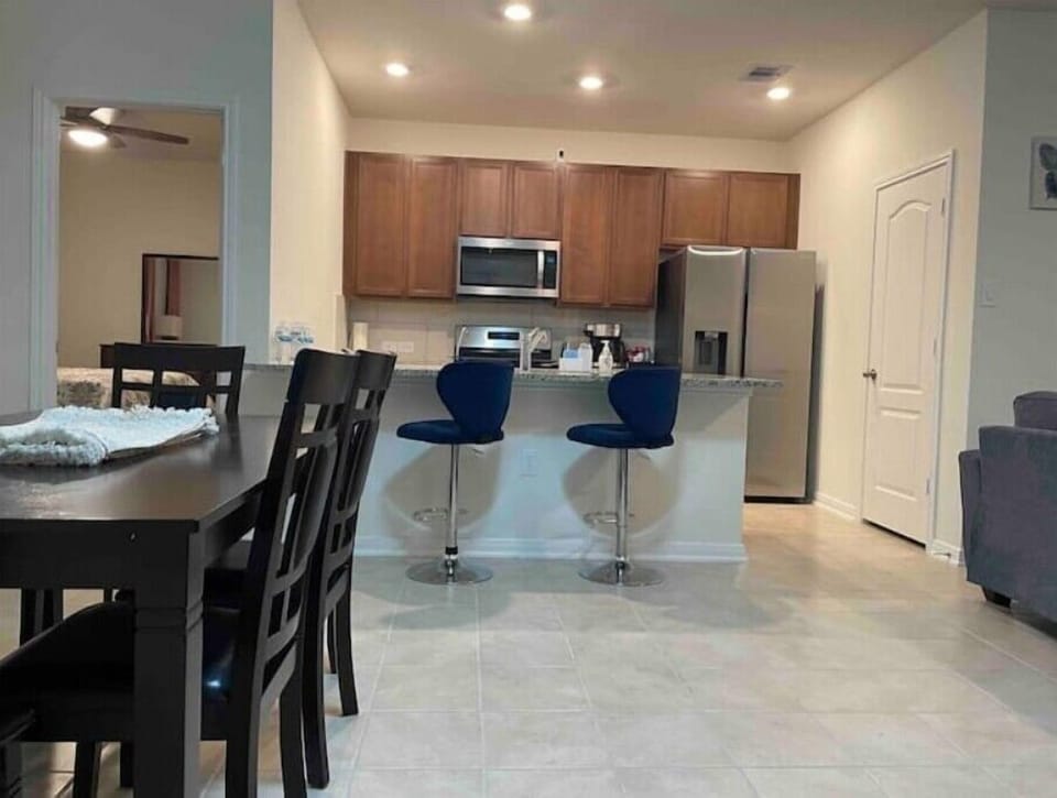 Kitchen with dining table and bar stools 