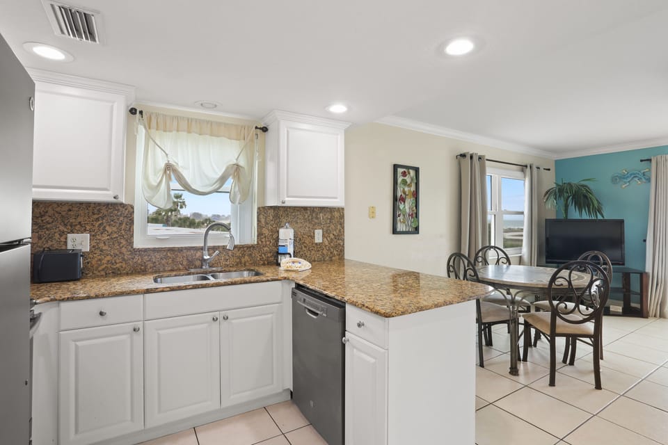 Full Kitchen With Stainless Steel Appliances.