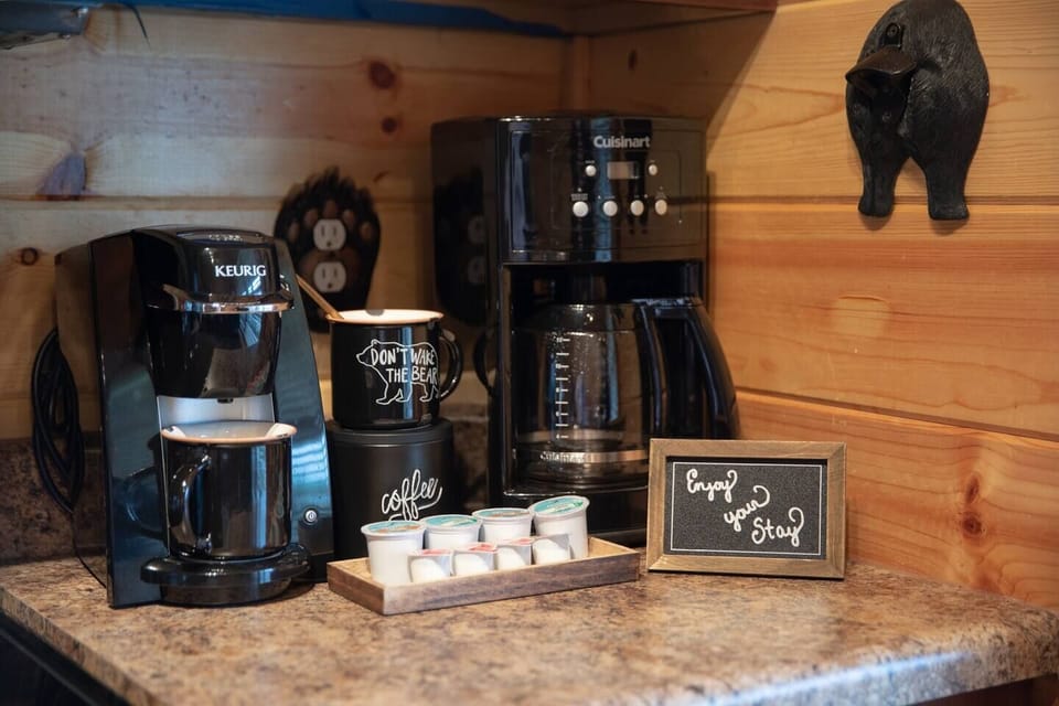 The kitchen features a coffee station with both a coffee pot and a Keurig. Oh, and a bear butt on the wall to open your bottles.
