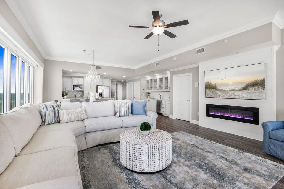 Relax on the sectional and watch the gulf coast through floor-to-ceiling windows as the fireplace creates a cozy vibe