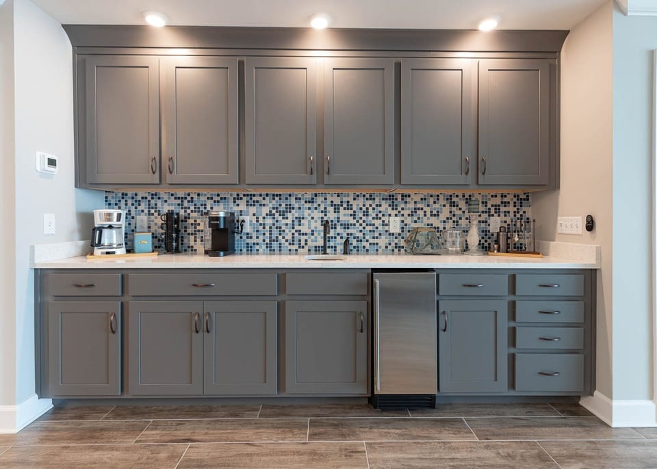 Brew coffee at the wet bar or grab a chilled drink from the mini fridge, and admire the mosaic backsplash