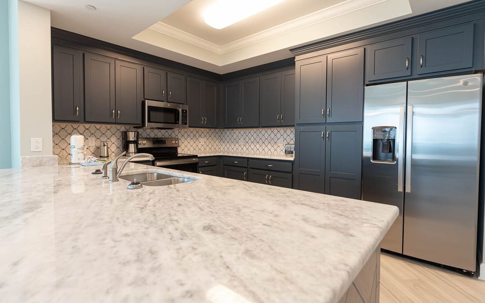 Prepare meals in this kitchen with elegant cabinetry, stainless appliances, and spacious countertops