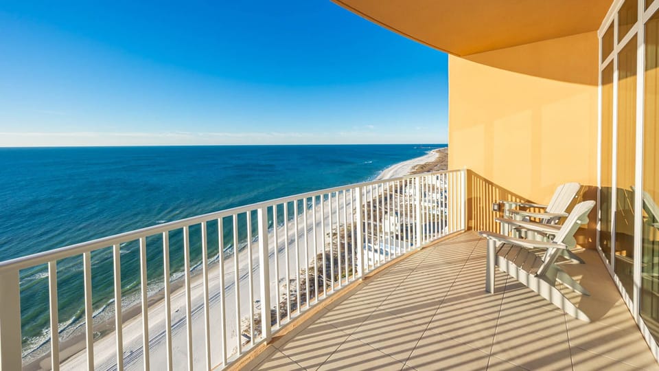 Relax in balcony chairs, listening to waves and watching the gulf and shore stretch into the distance
