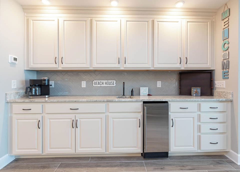 Chill drinks in the steel-front mini fridge, admire the herringbone tile backsplash and relax
