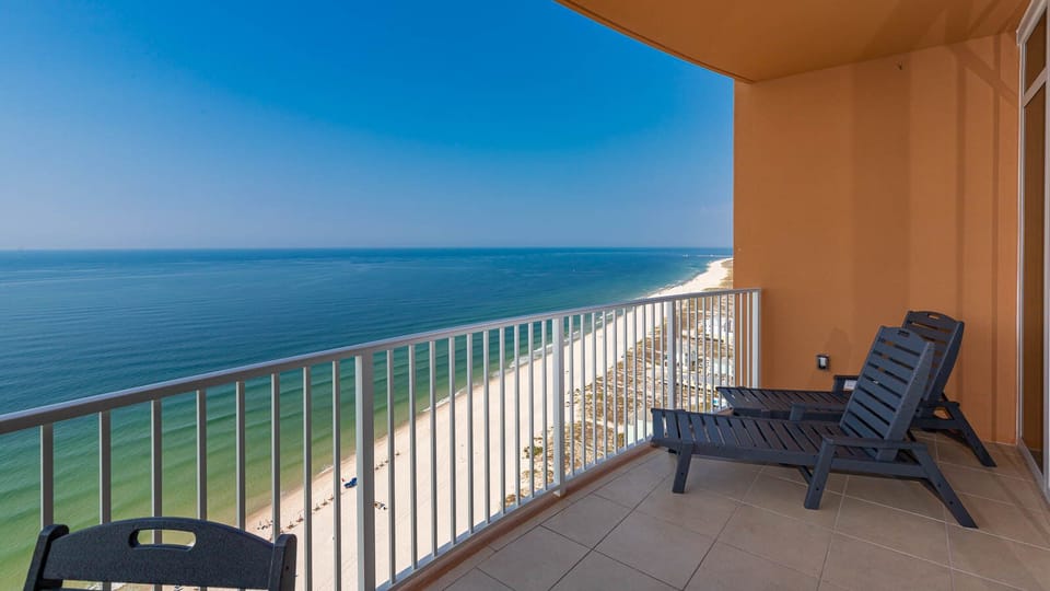 Breathe gulf air on the balcony chaise and watch the beachfront stretch below