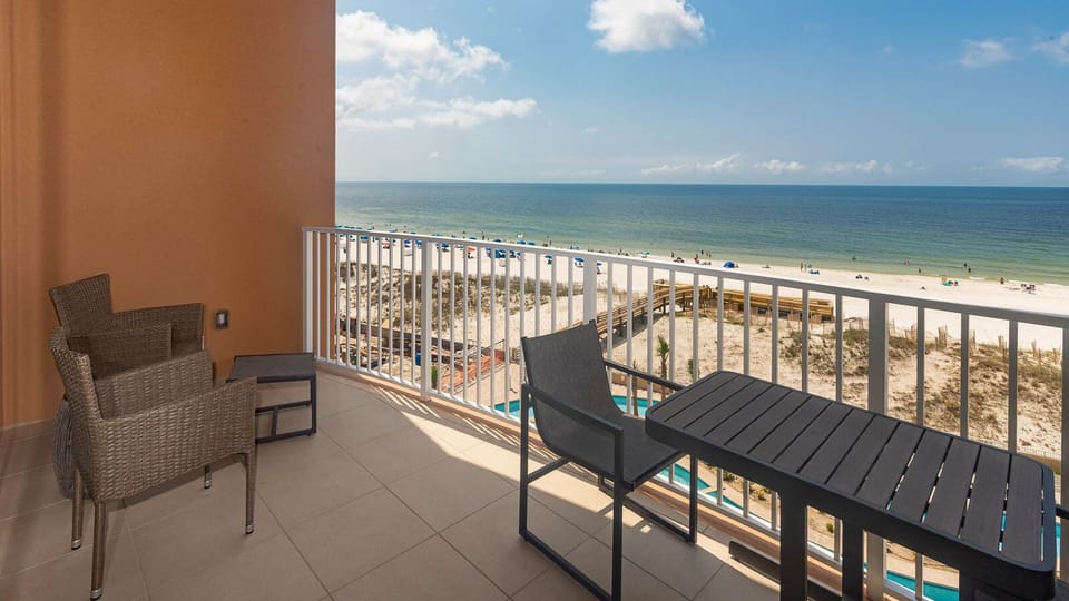 Unwind on a balcony chair, feel the gulf breeze, and watch the beach glisten in the sun