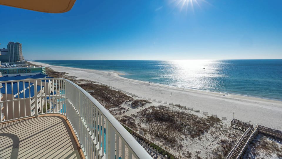 Step onto the balcony with stunning coastline views and feel warm sun on your skin
