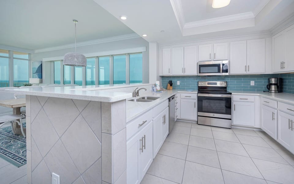Prepare meals in this elegant kitchen while watching the beach and gulf horizon through the windows