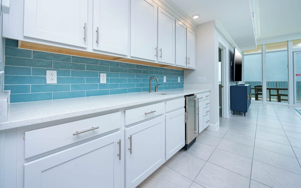 Pour your favorite drink from the wet bar or chilled beverage from the under cabinet fridge